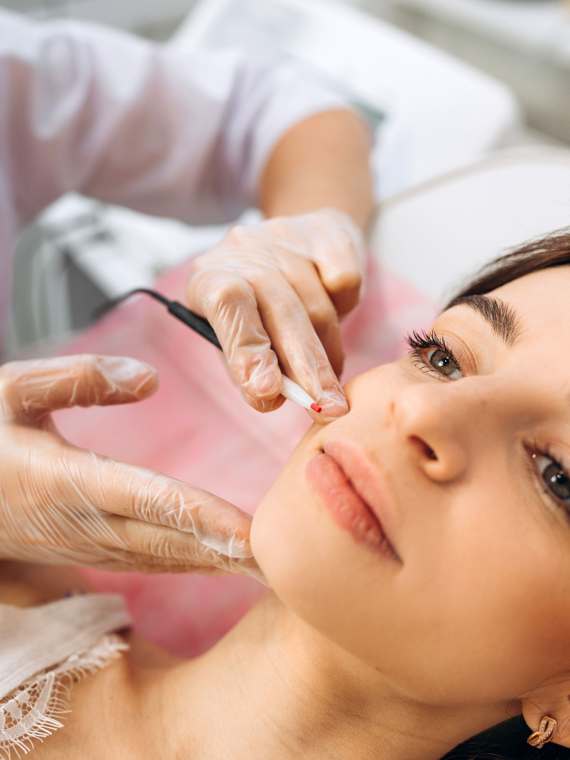 A woman is getting a facial treatment at a beauty salon.