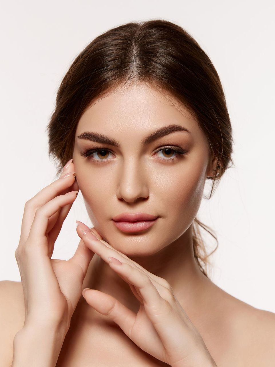 A woman touching her face.