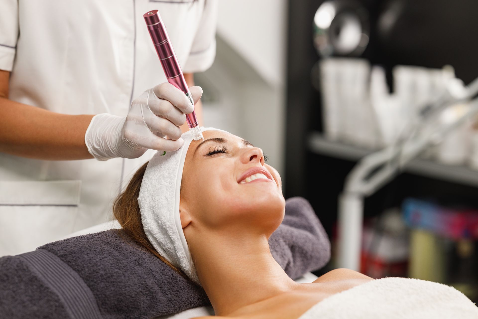 A woman is getting a facial treatment at a beauty salon.