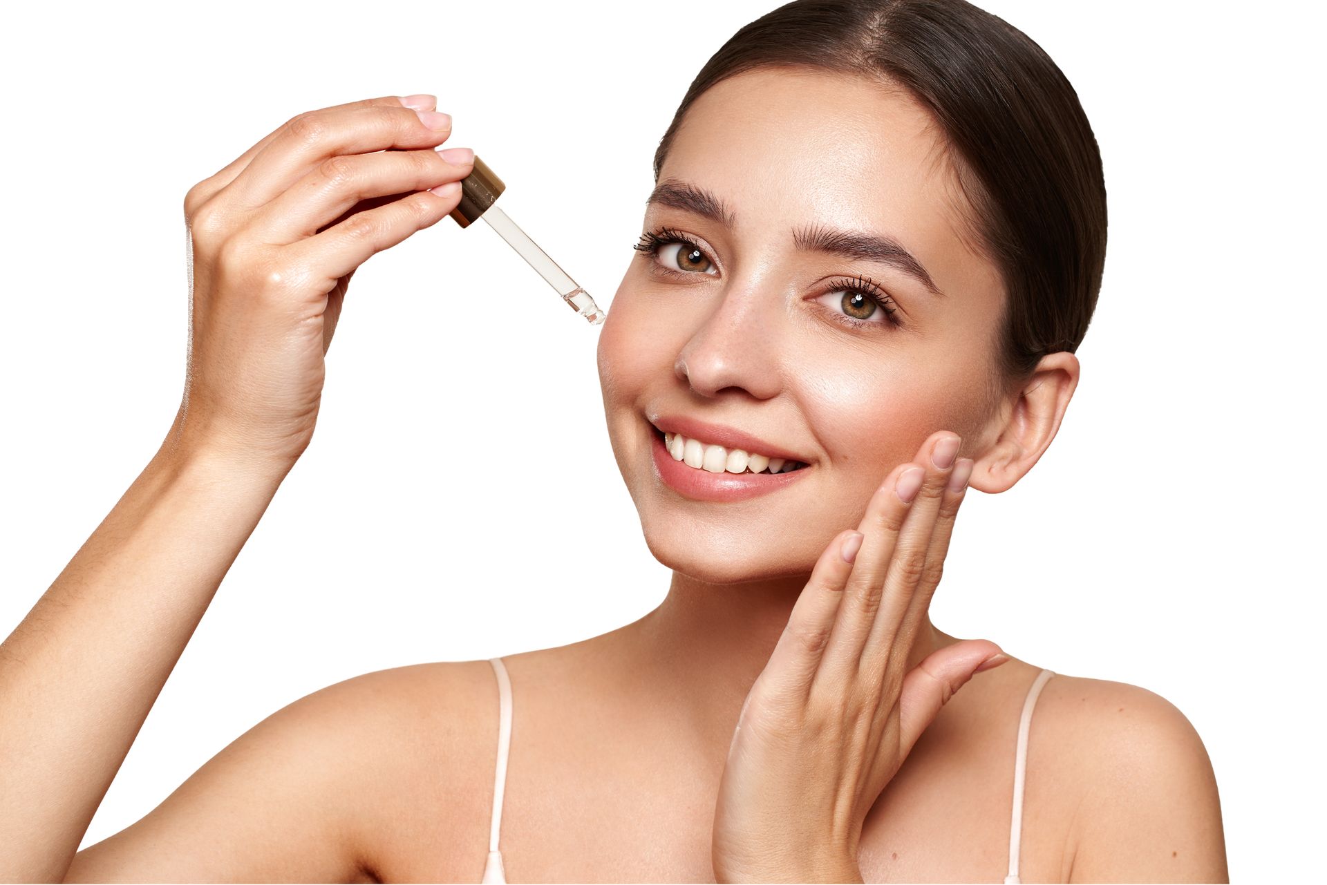 Woman applying serum to her face with a dropper, smiling.