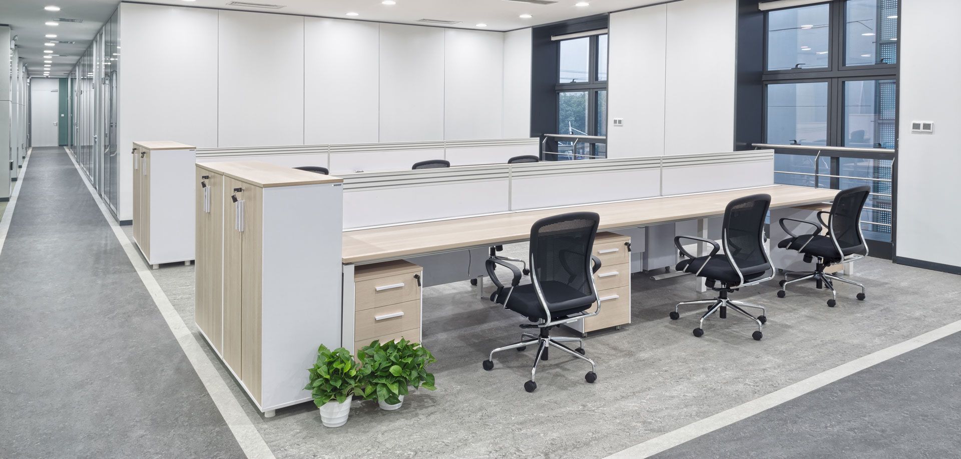 There are a lot of desks and chairs in this office.