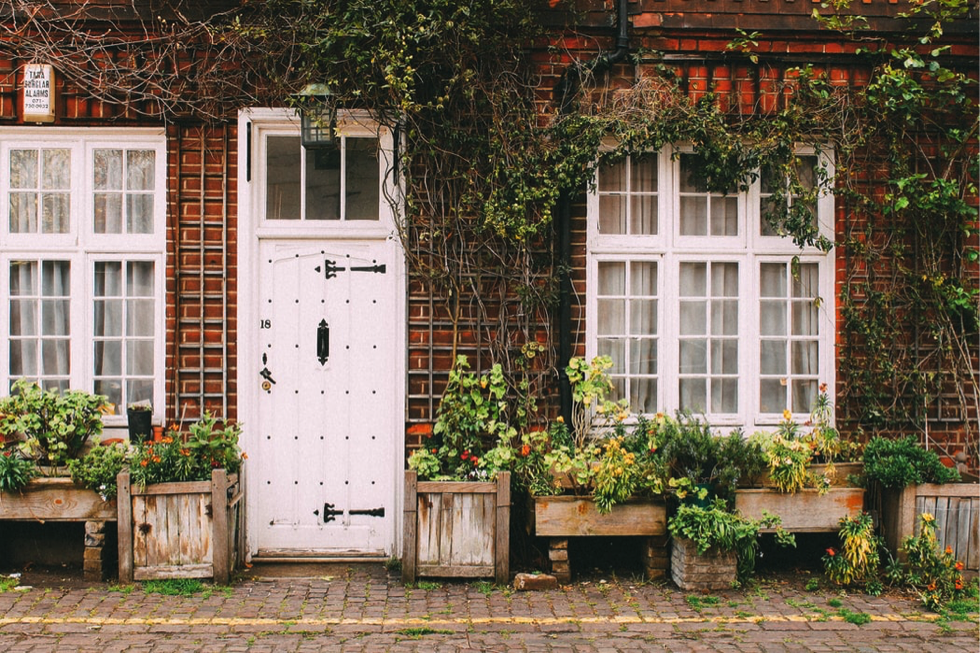 The front of a home with door and potted plants