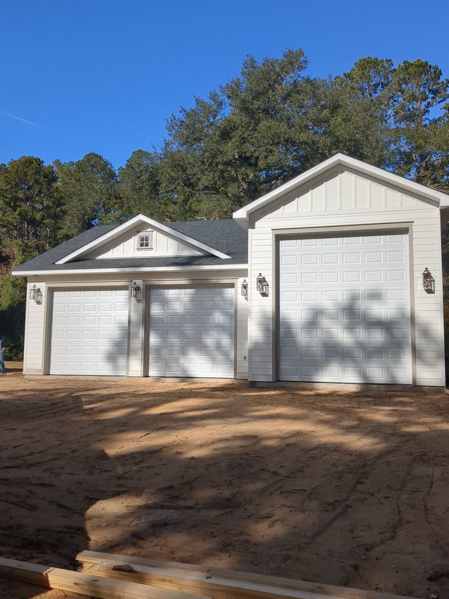 A small black house with a roof and a lot of windows.