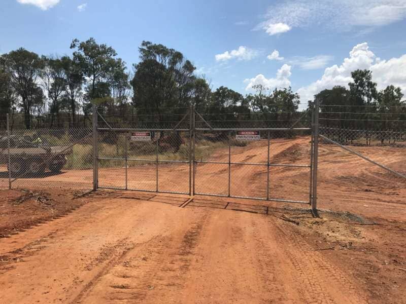A Dirt Road With A Gate In The Middle Of It — Mulch, Fencing And Landscaping Mackay, QLD
