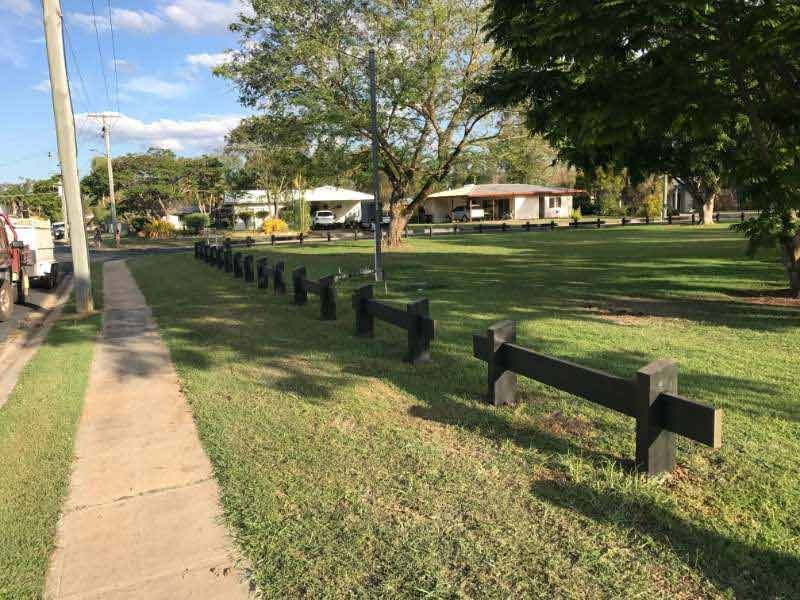 A Wooden Fence Along A Sidewalk In A Park — Garden Fencing Installations In Mackay And Surrounds, QLD