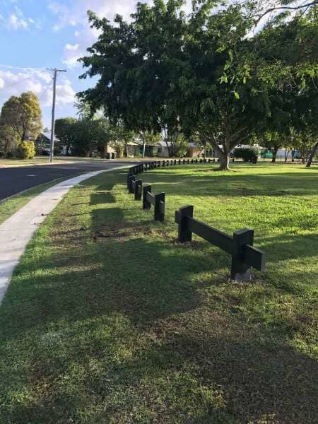 A Wooden Fence Along A Sidewalk In A Park — Mulch, Fencing And Landscaping Mackay, QLD