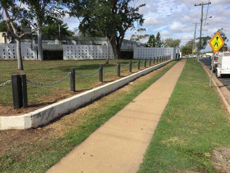 A Sidewalk With A Fence And A Sign That Says A On It — Mulch, Fencing And Landscaping Mackay, QLD