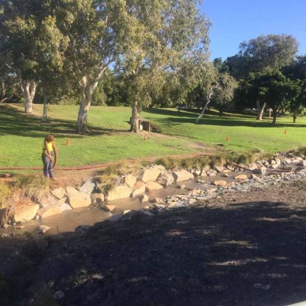 A Person Is Standing On A Rocky Path In A Park — Mulch, Fencing And Landscaping Mackay, QLD