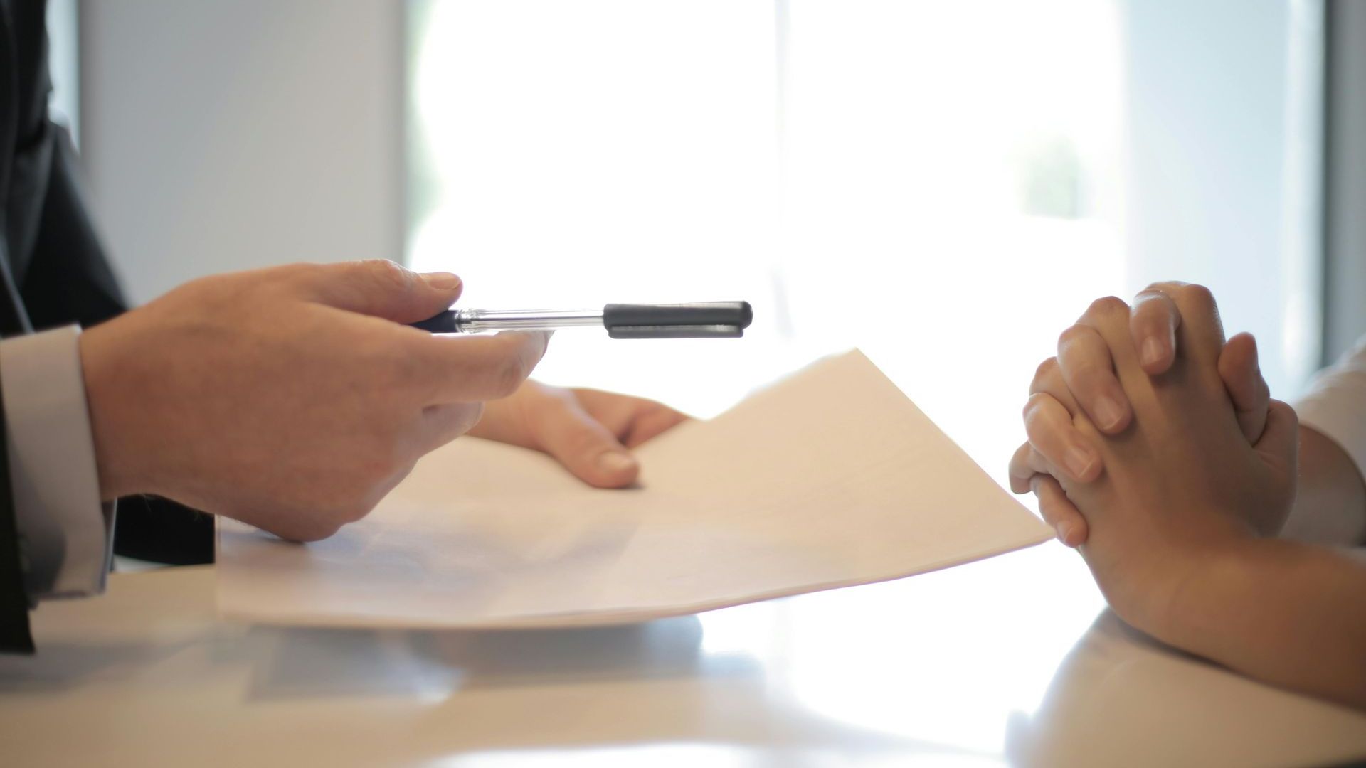 A man is giving a piece of paper to a woman.