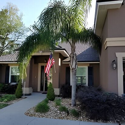 A house with a palm tree and an american flag