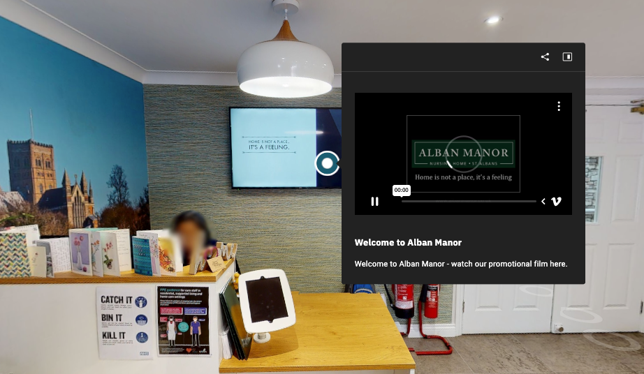 A camera is sitting on a tripod in a room.