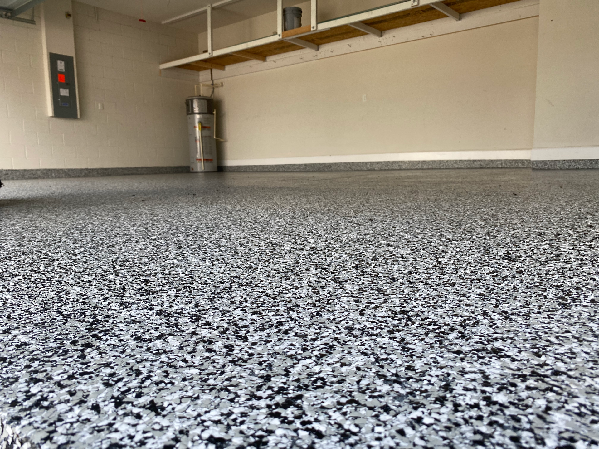 A close up of a garage floor with a lot of small rocks on it.
