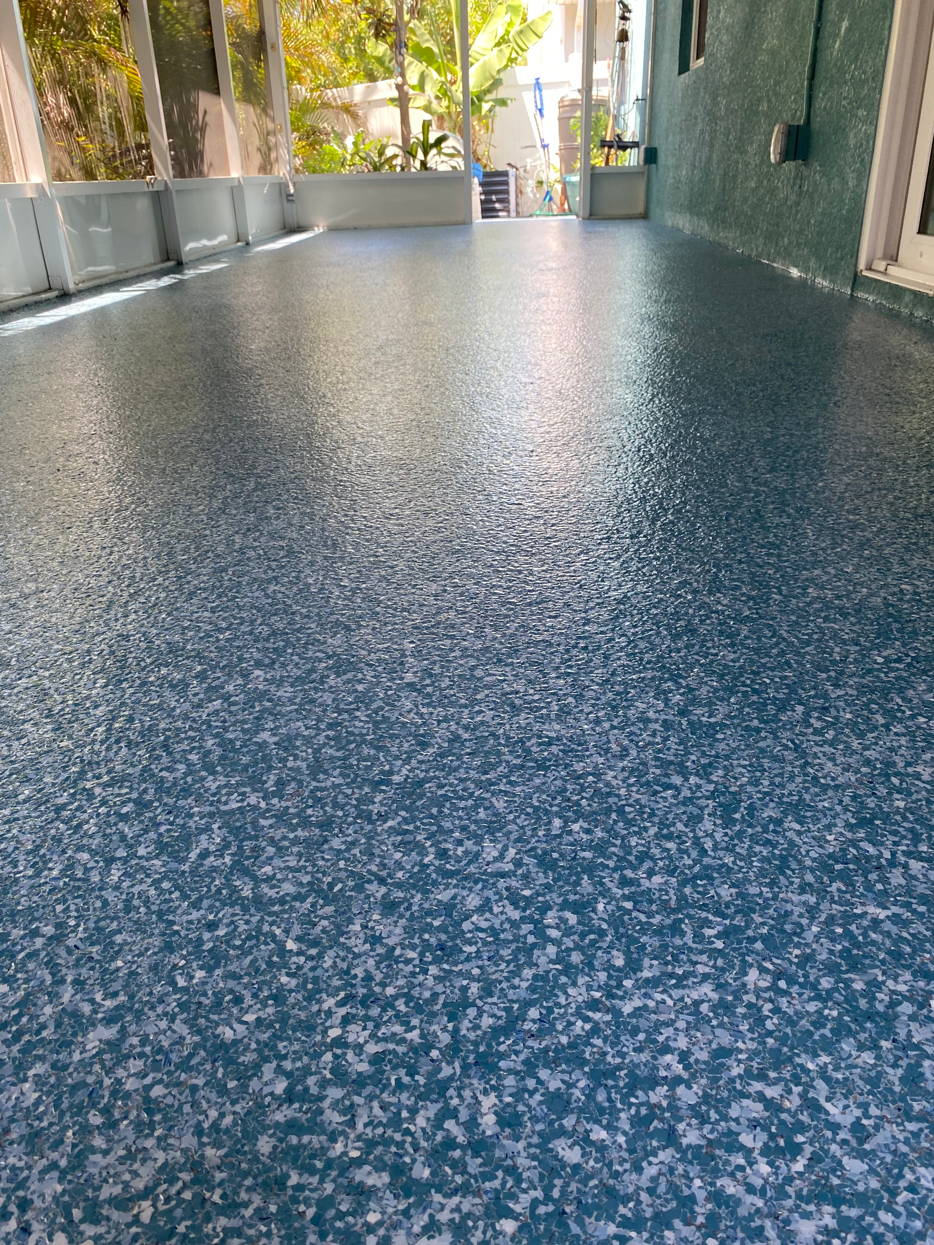 A blue and white floor with a lot of small stones on it.