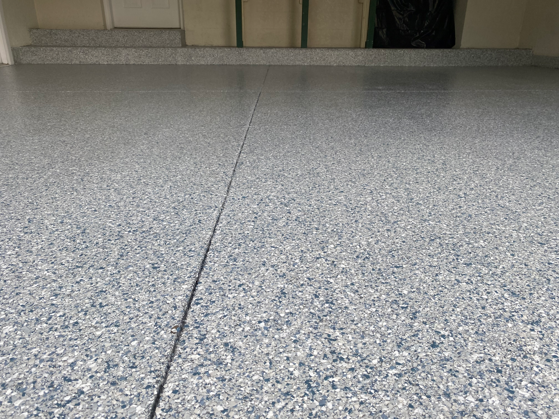 A close up of a gray concrete floor in a garage.