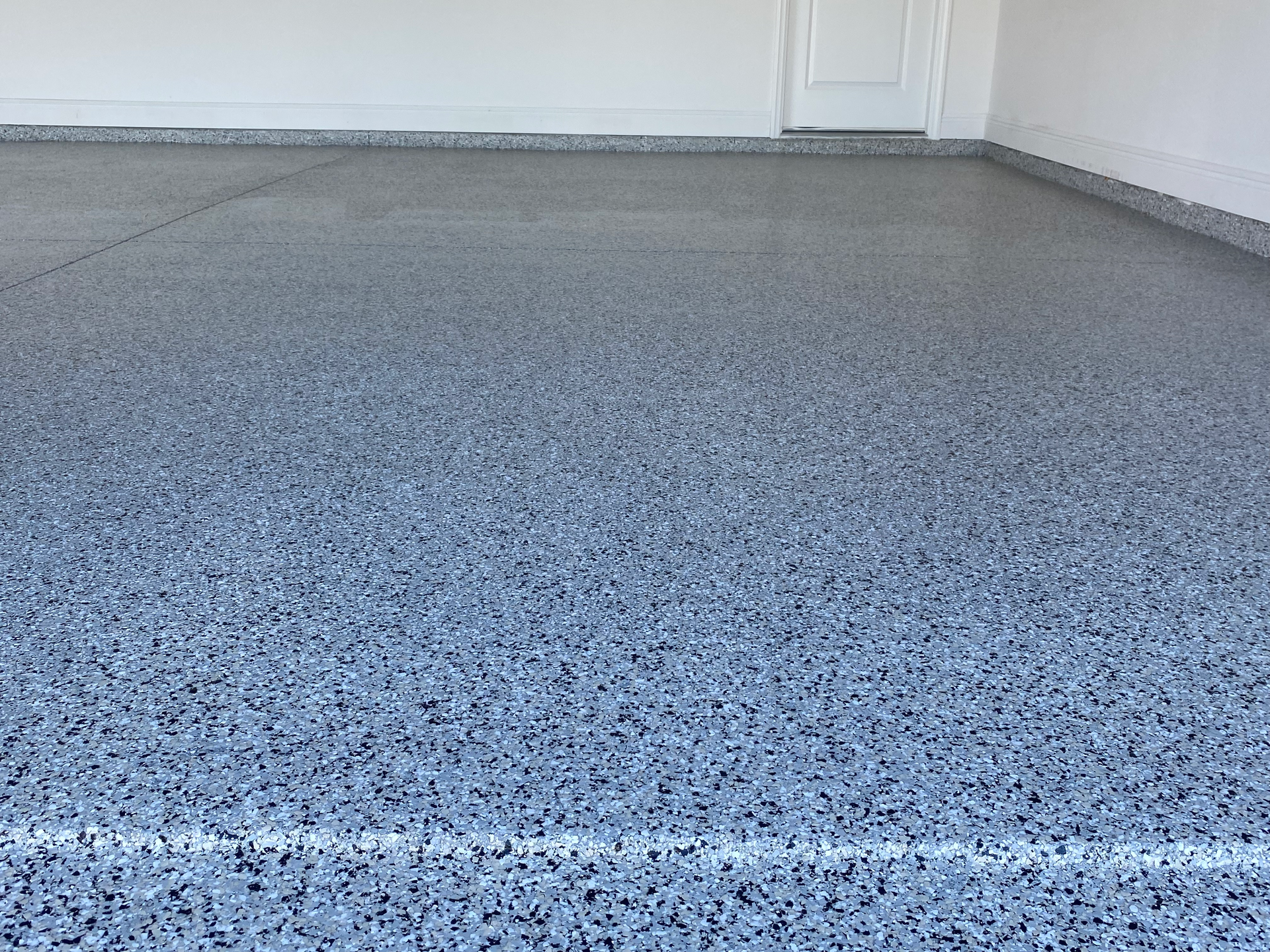 A close up of a gray concrete floor in a garage.