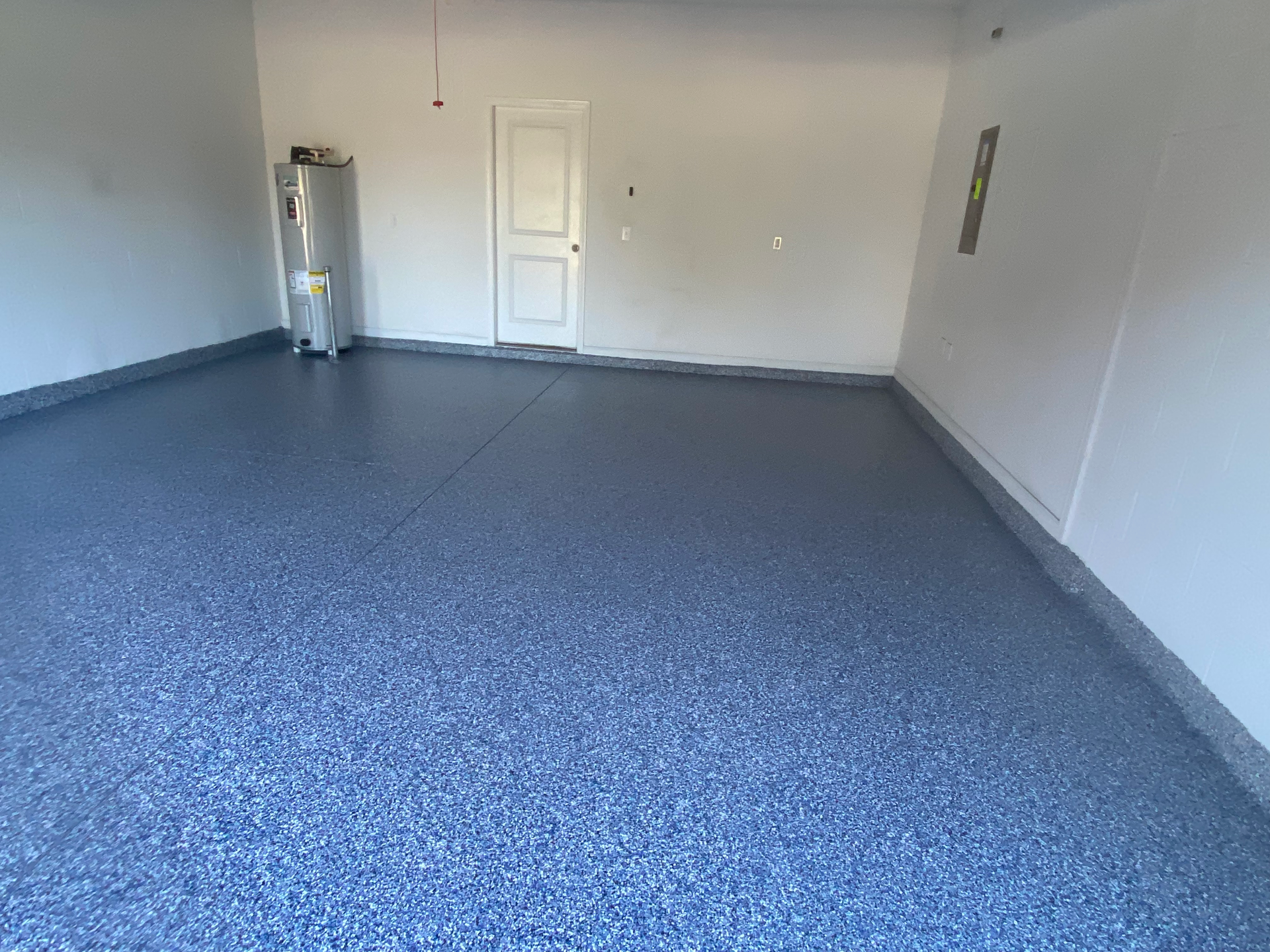 A garage with a blue floor and white walls.