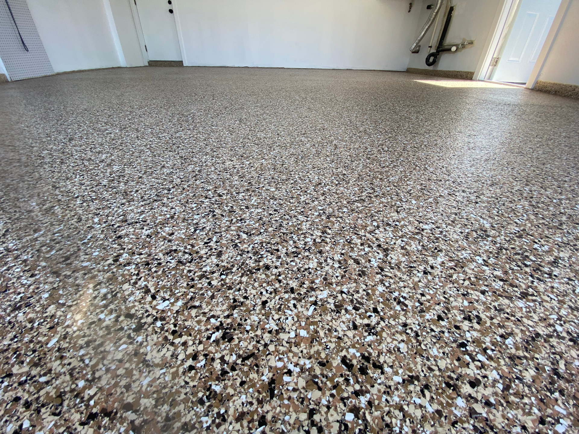 A garage floor with a lot of small rocks on it.