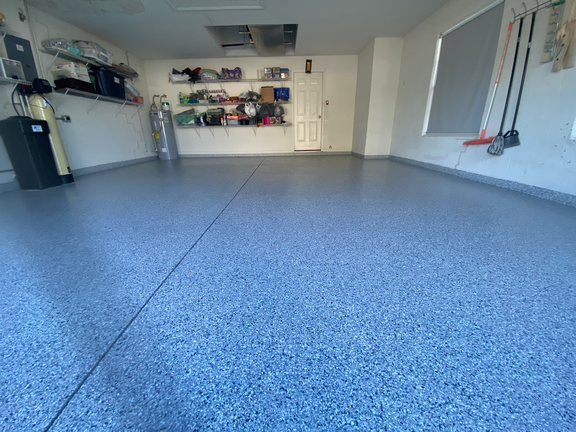 A garage with a blue floor and white walls.