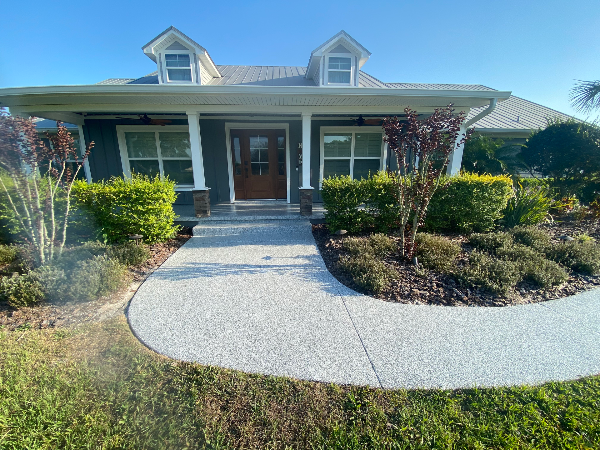 The front of a house with a walkway leading to it.
