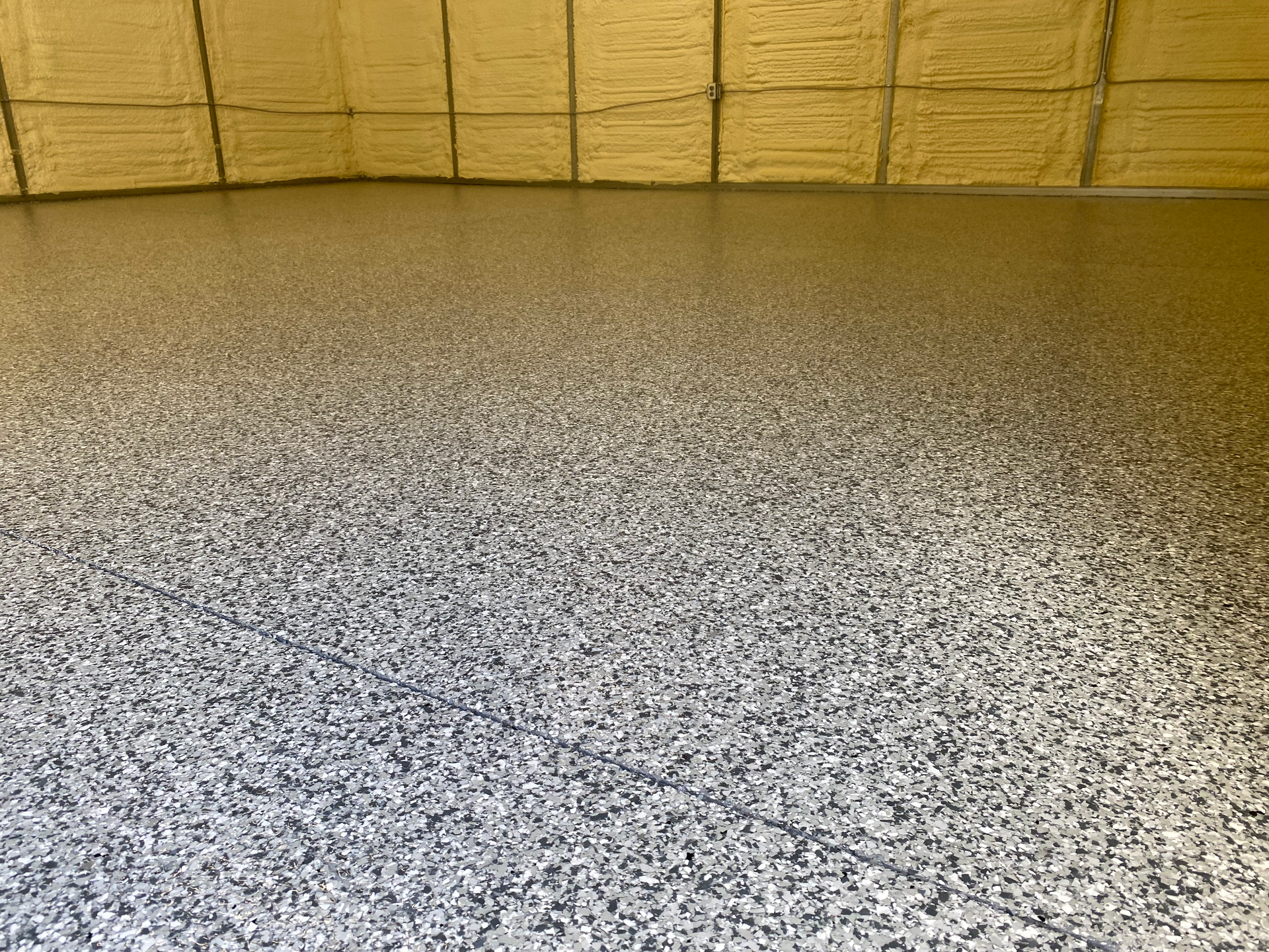 A garage floor with a lot of small stones on it.