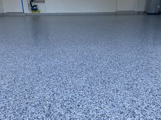 A close up of a blue concrete floor in a garage.