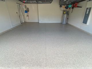 A garage with a concrete floor and white walls.