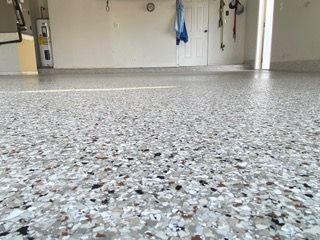 A garage floor with a lot of small rocks on it.