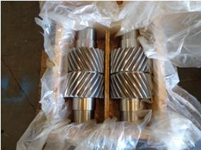 A box filled with metal gears wrapped in plastic.