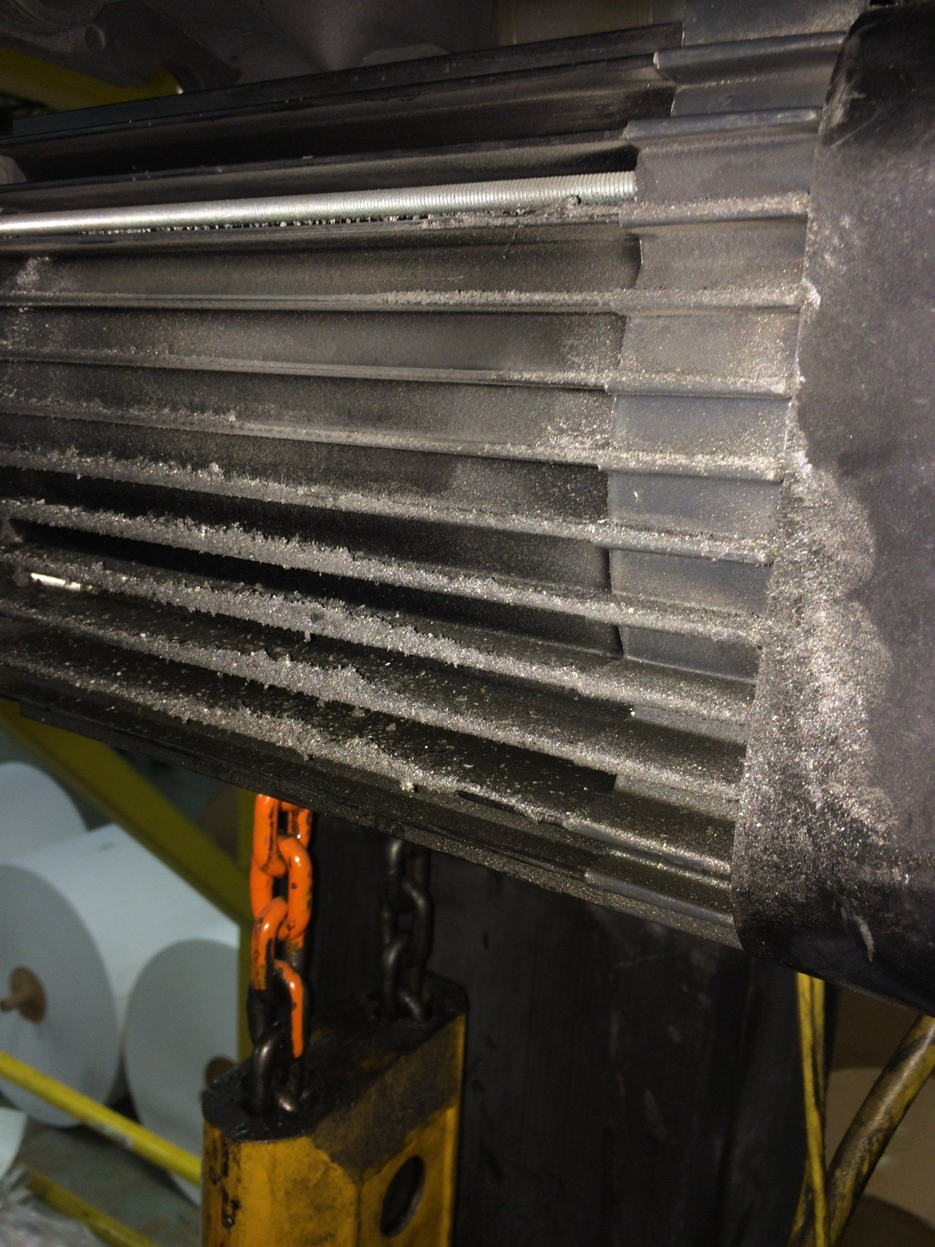 A close up of a machine with a chain attached to it