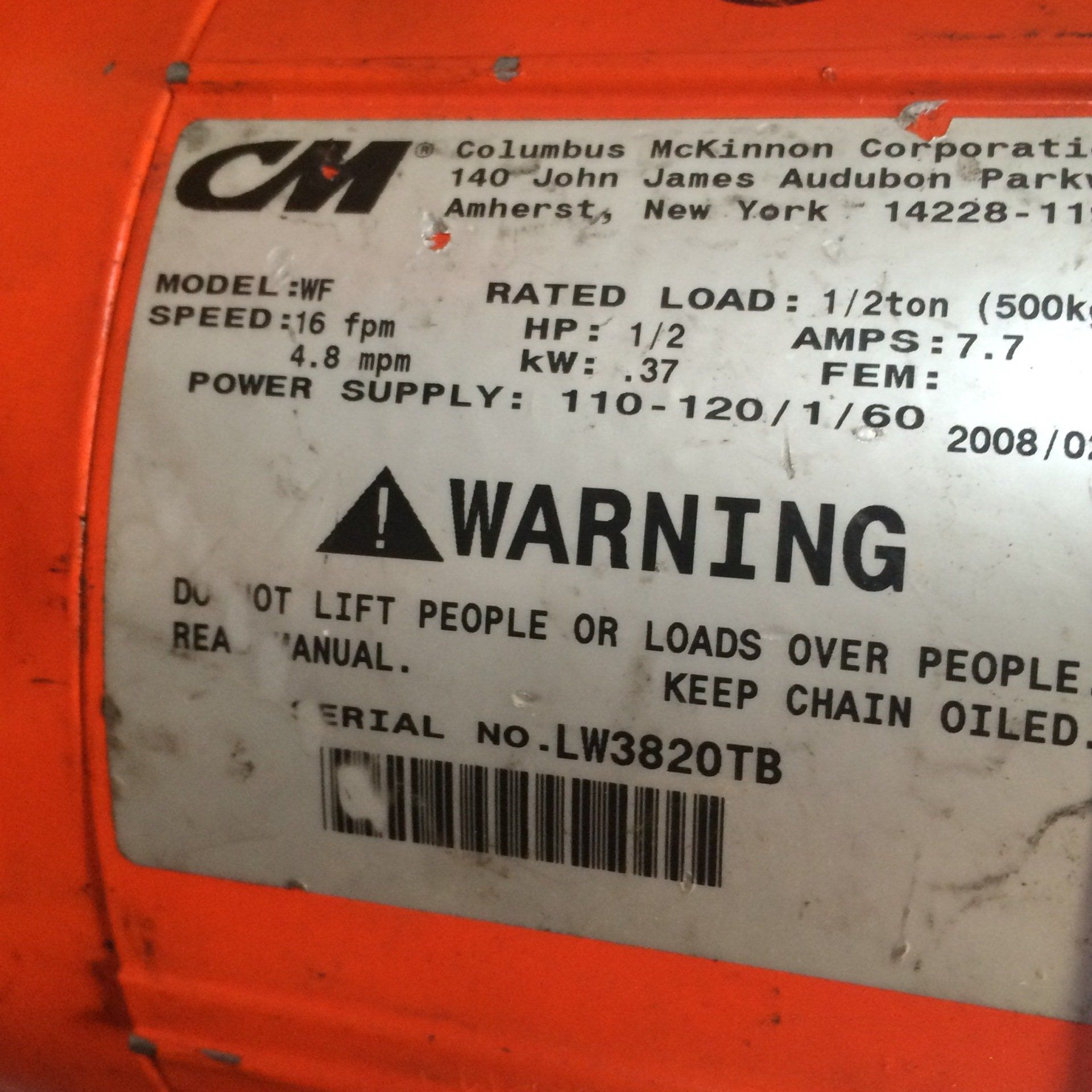 A close up of a warning label on a machine