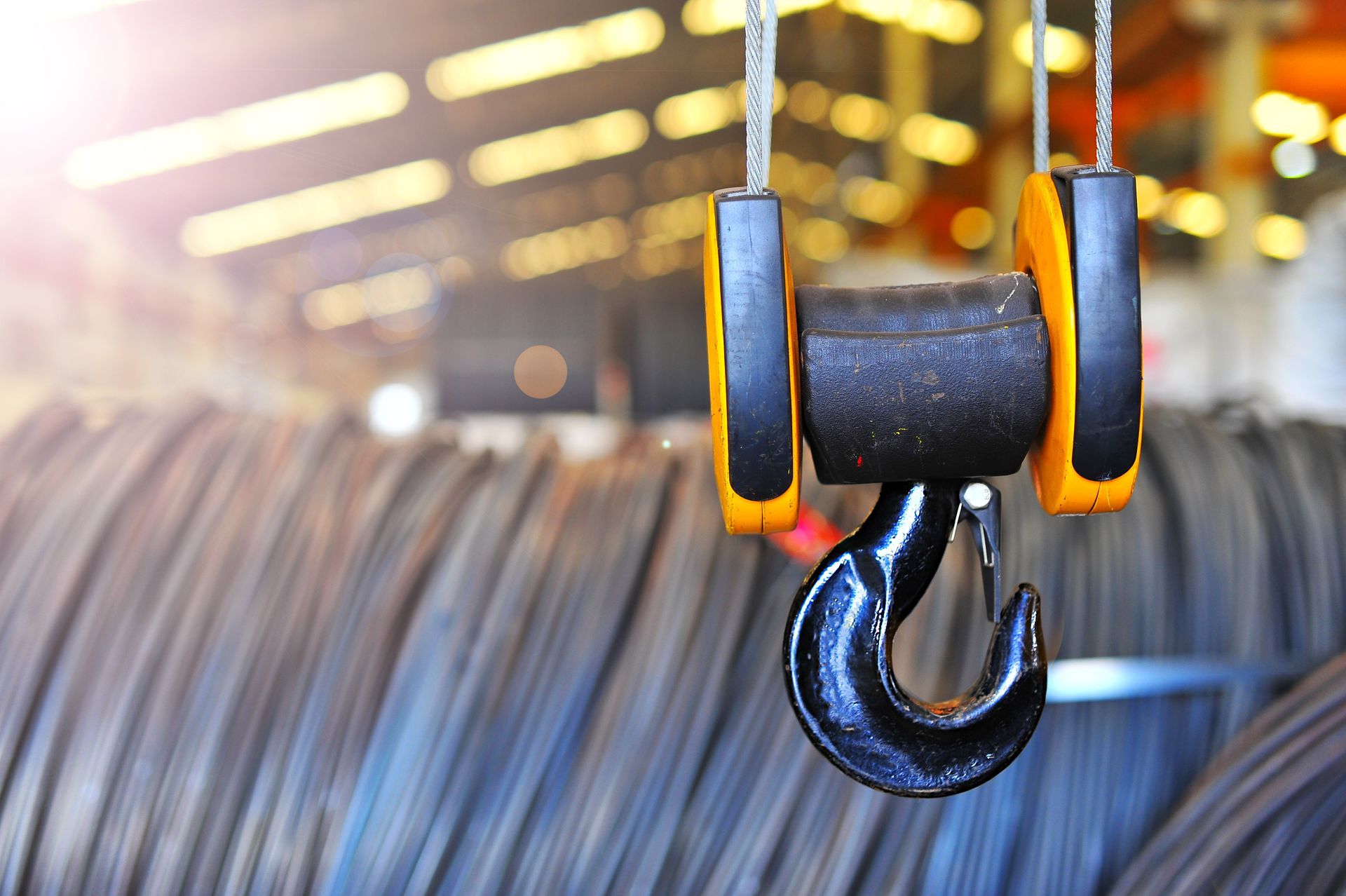 A close up of a hook hanging from a crane.