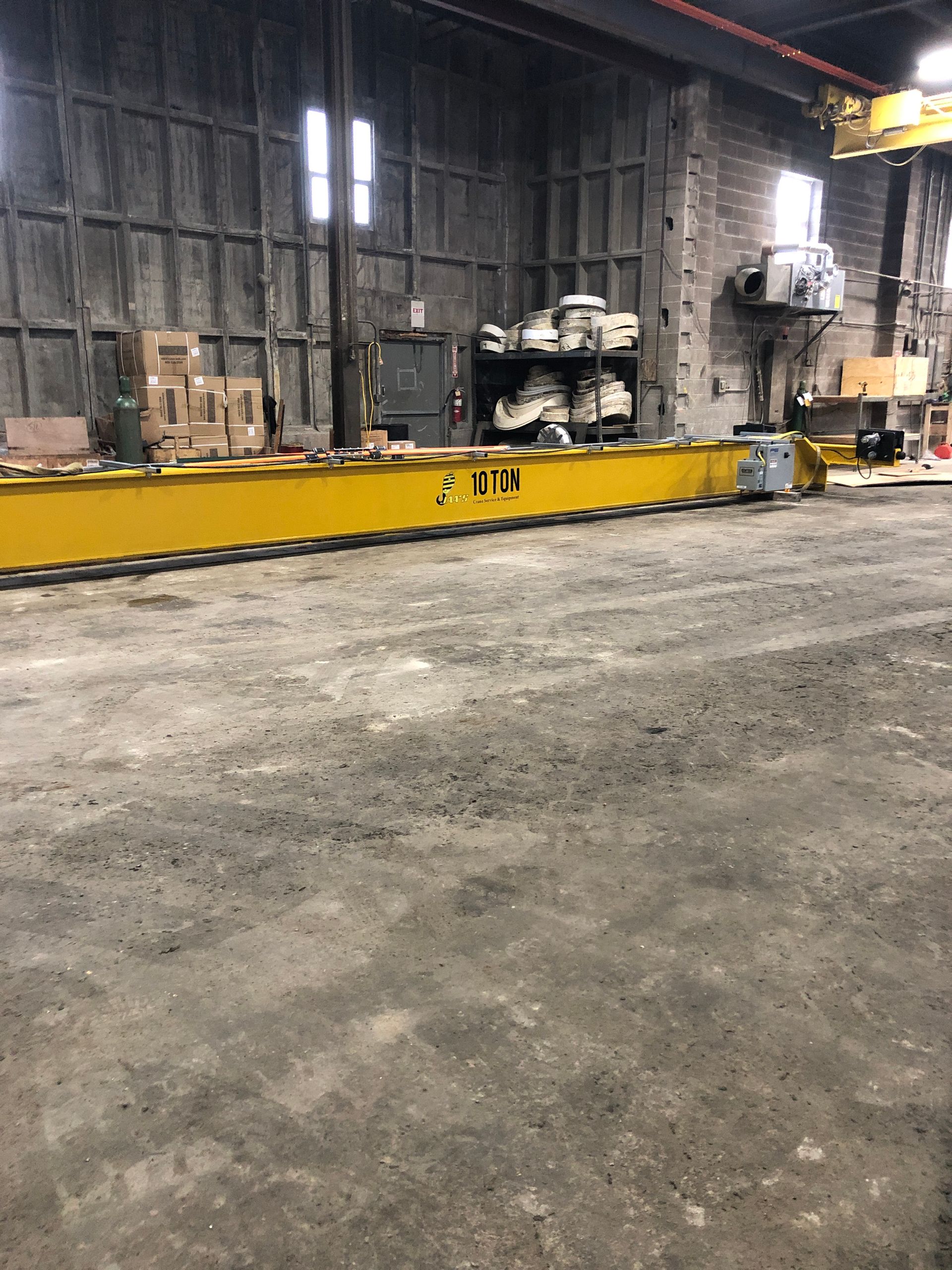 A warehouse with a yellow crane that says only on it