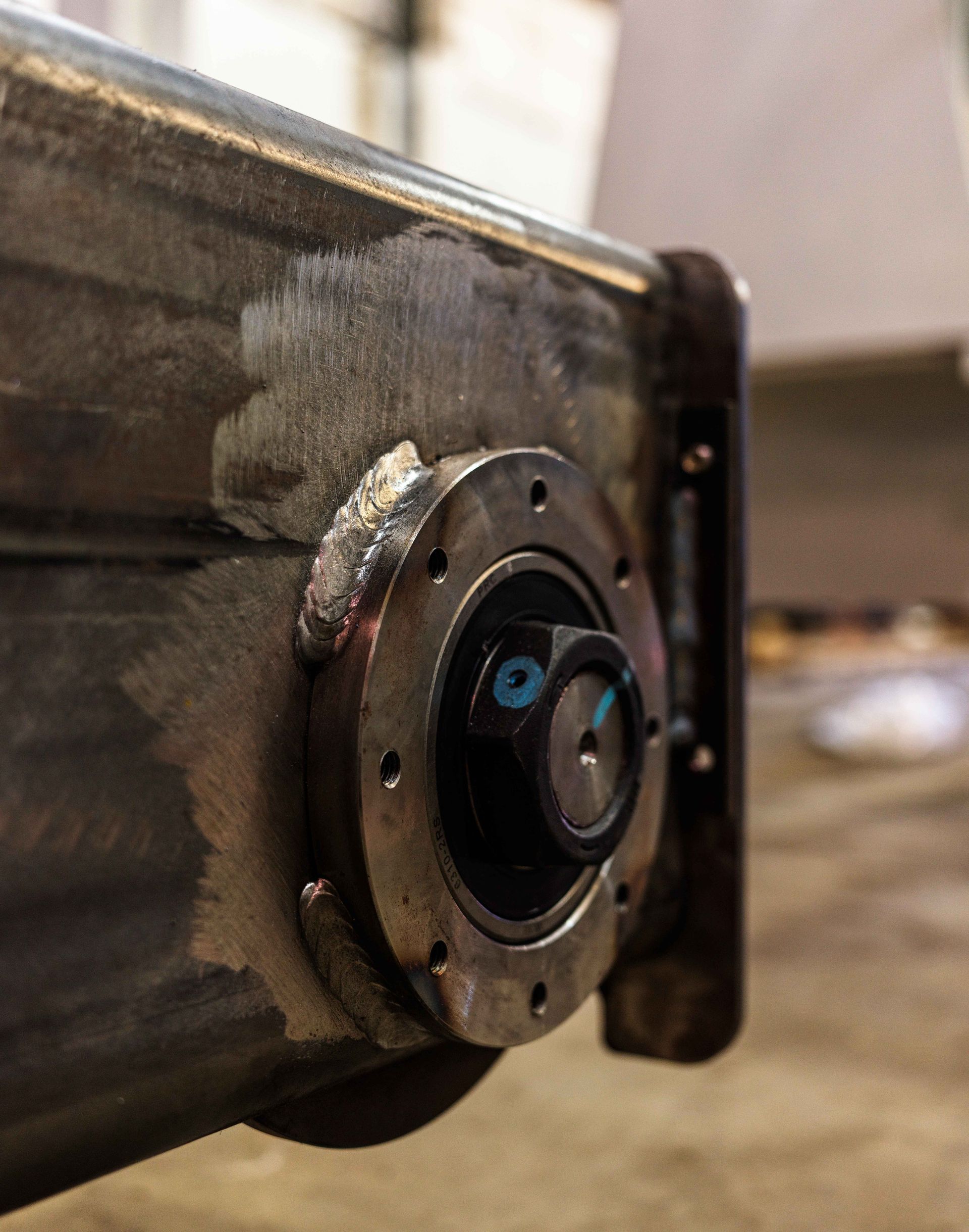 A close up of a metal object with a screw on it