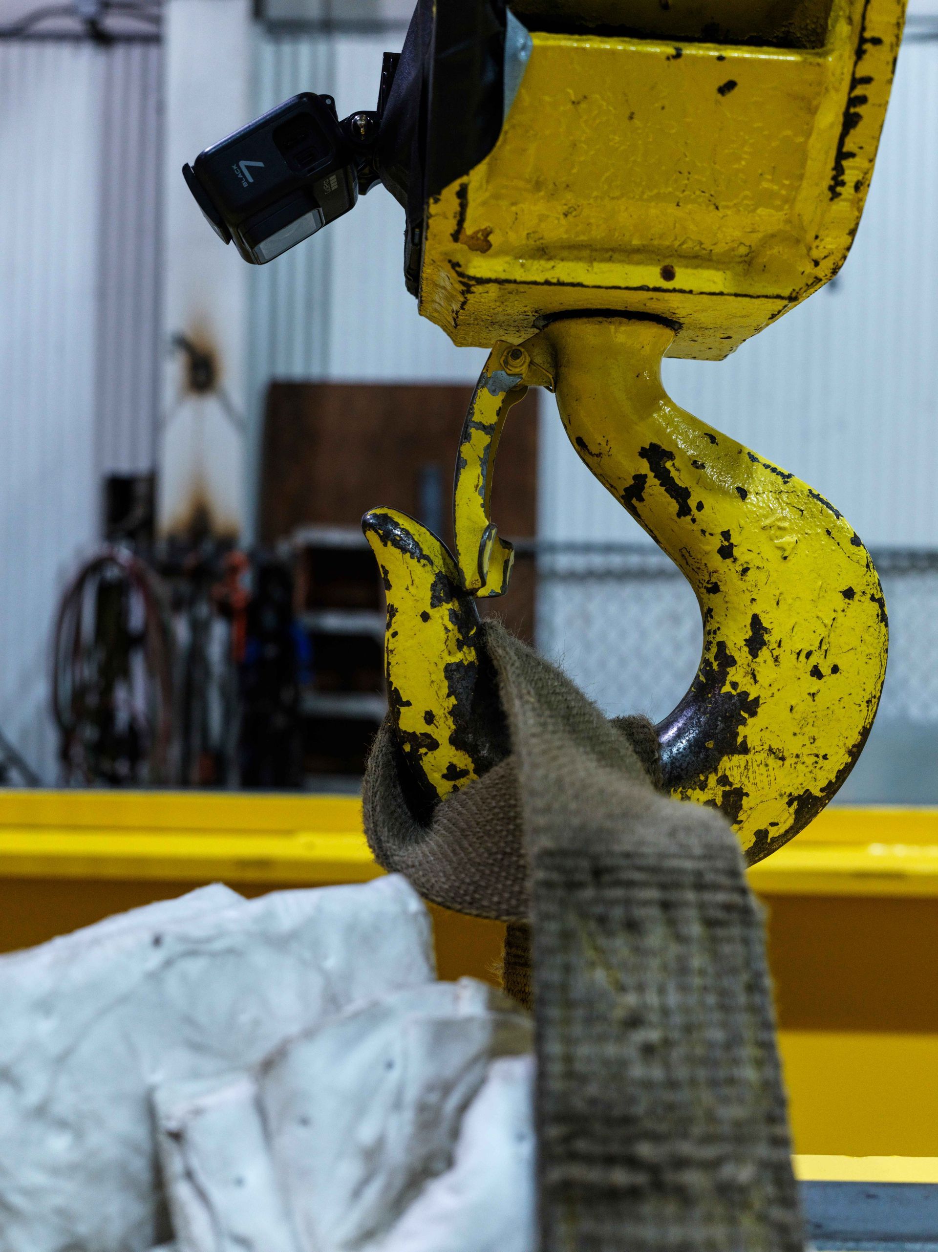 A yellow hook with a sling attached to it