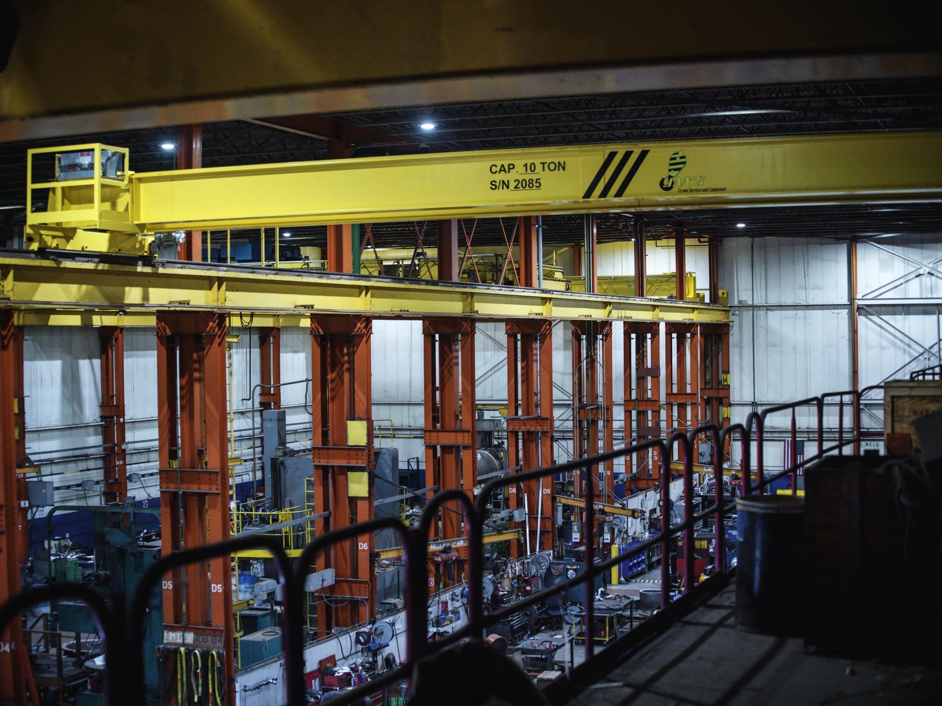 A large yellow crane is in a large building