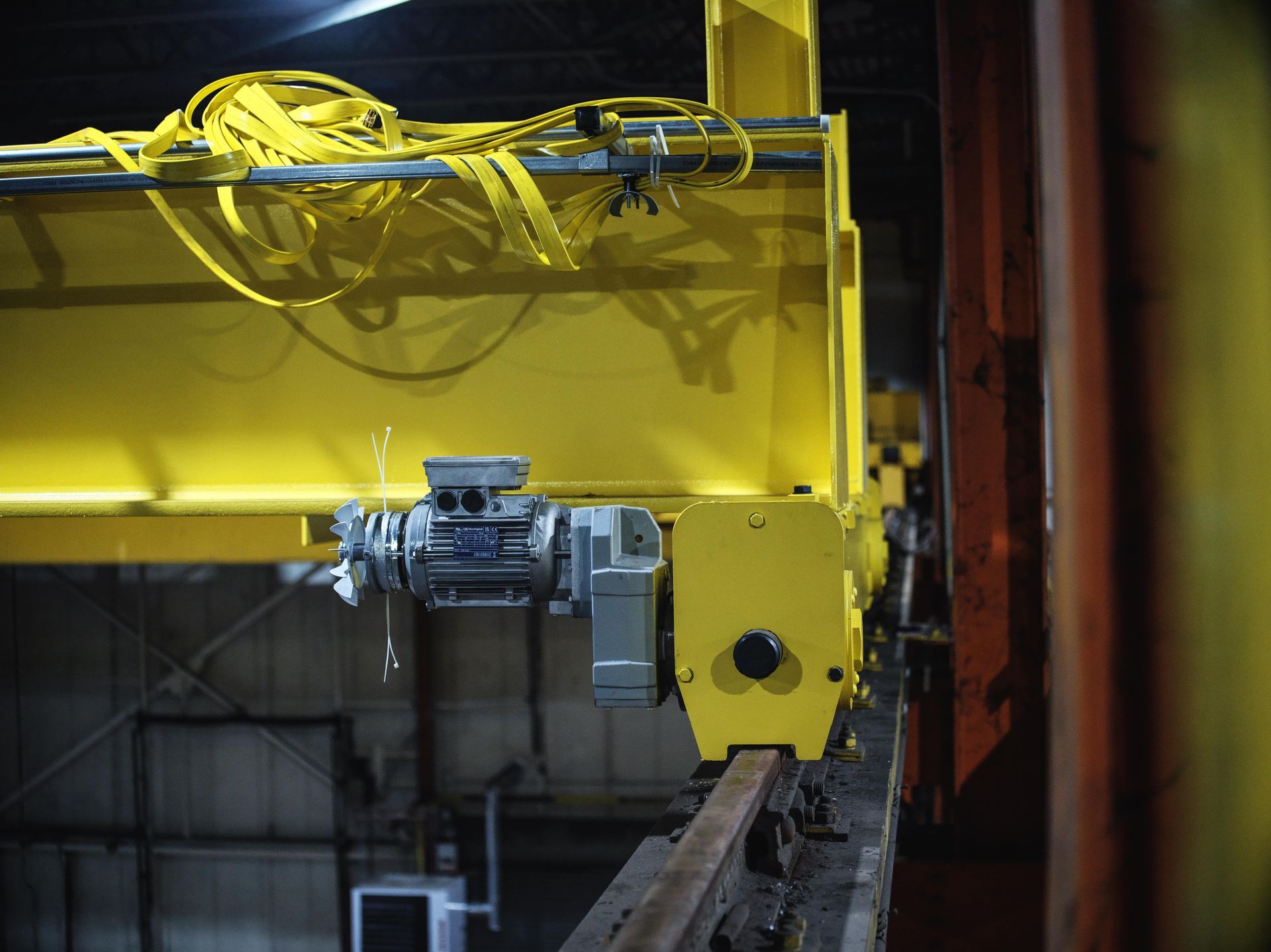 A yellow crane is sitting in a dark room