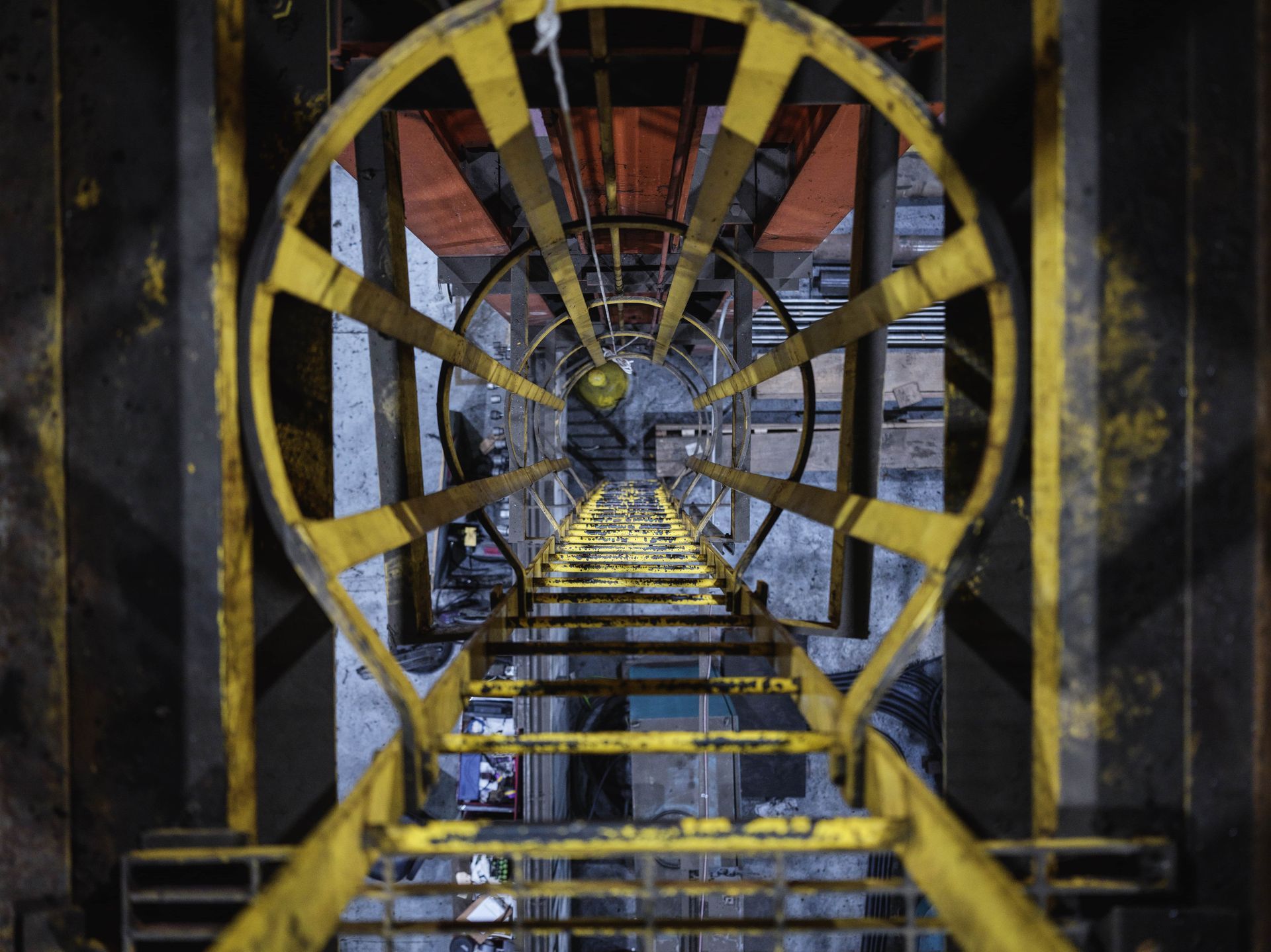 Looking down a yellow staircase in a dark room