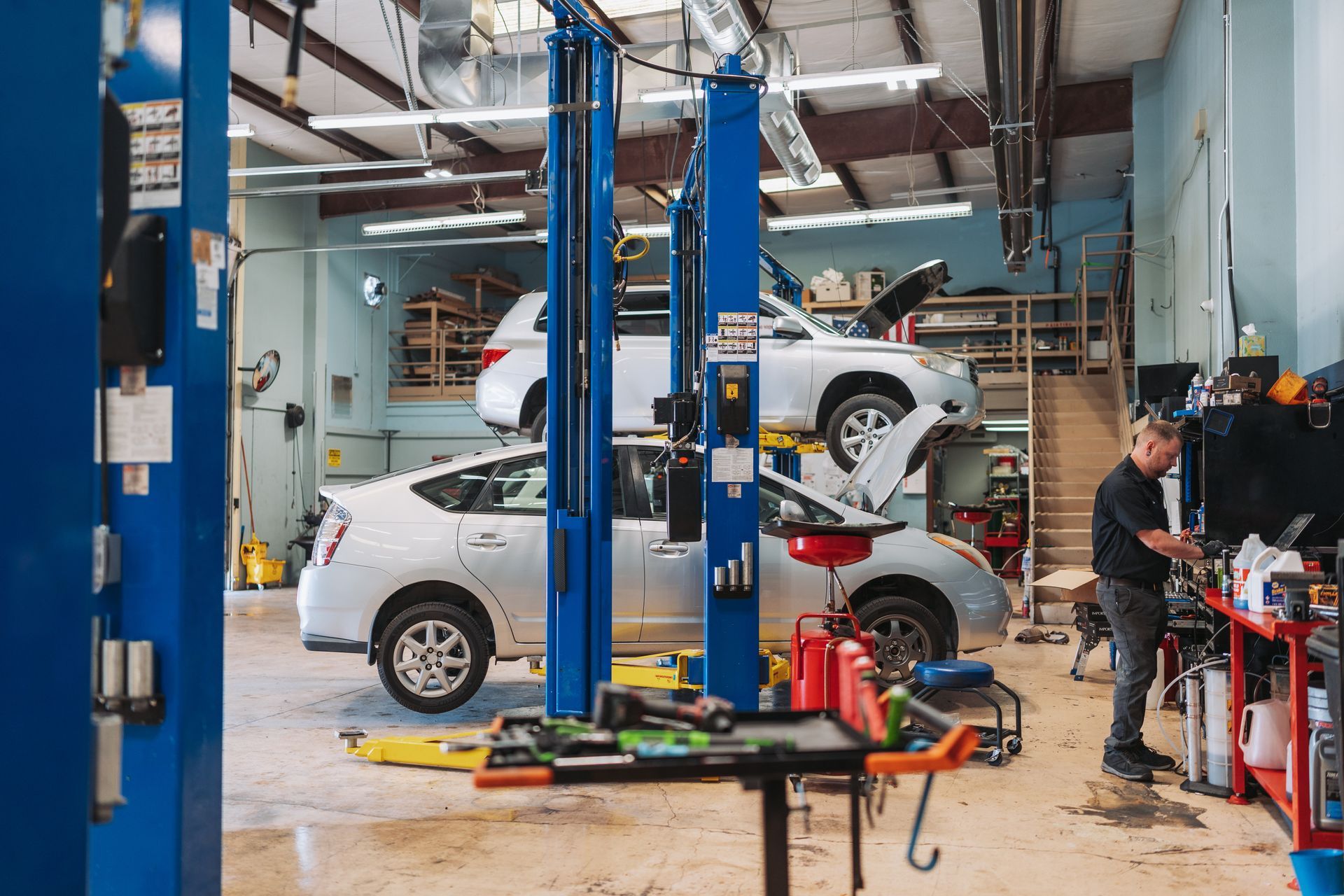 A man is working on a car in a garage.
