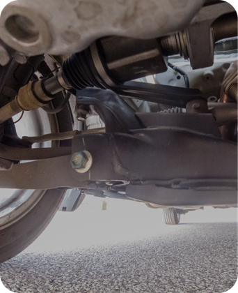 A close up of the underside of a car 's suspension system. | Japanese Car Care