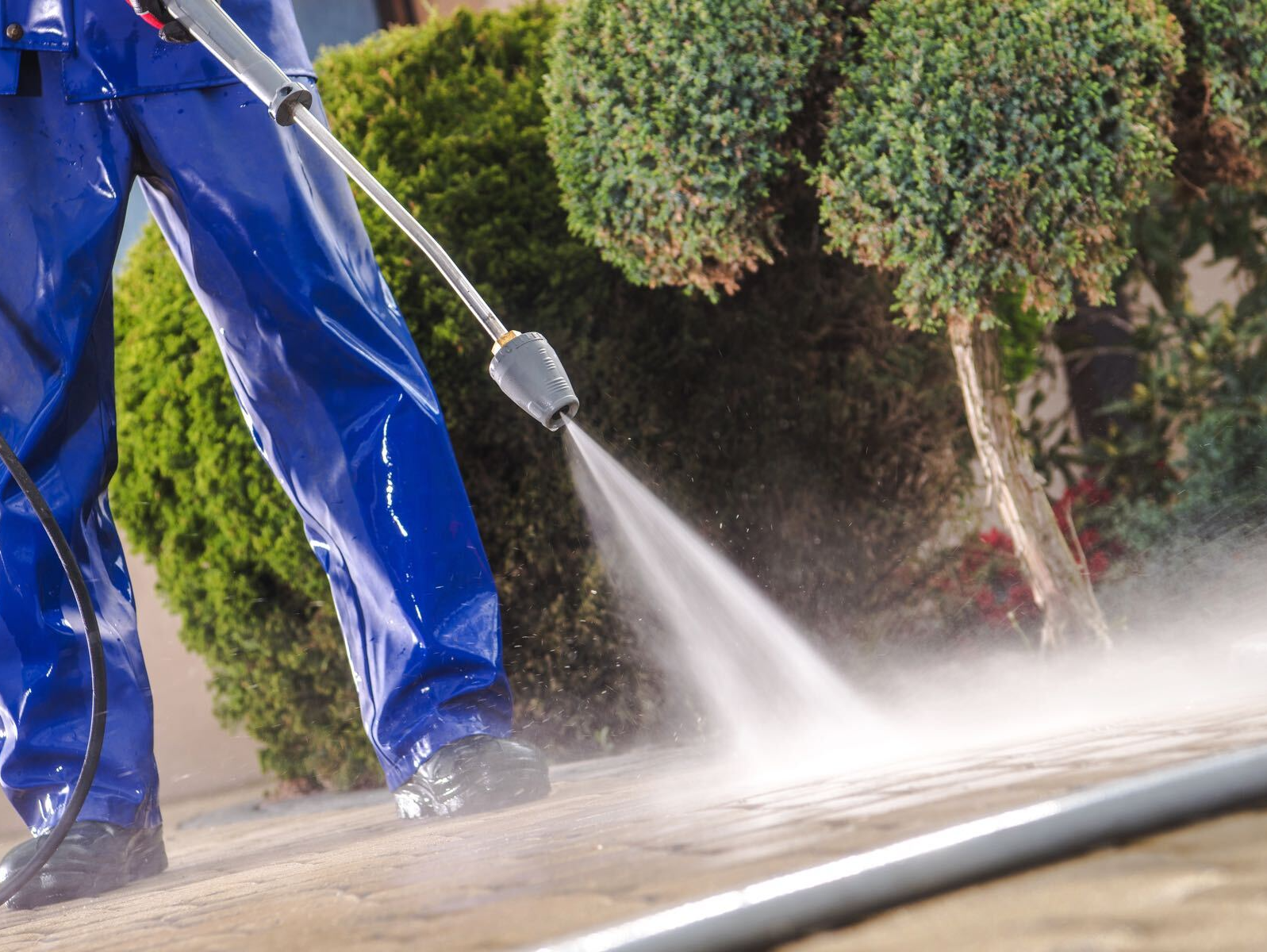 person power washing sidewalk