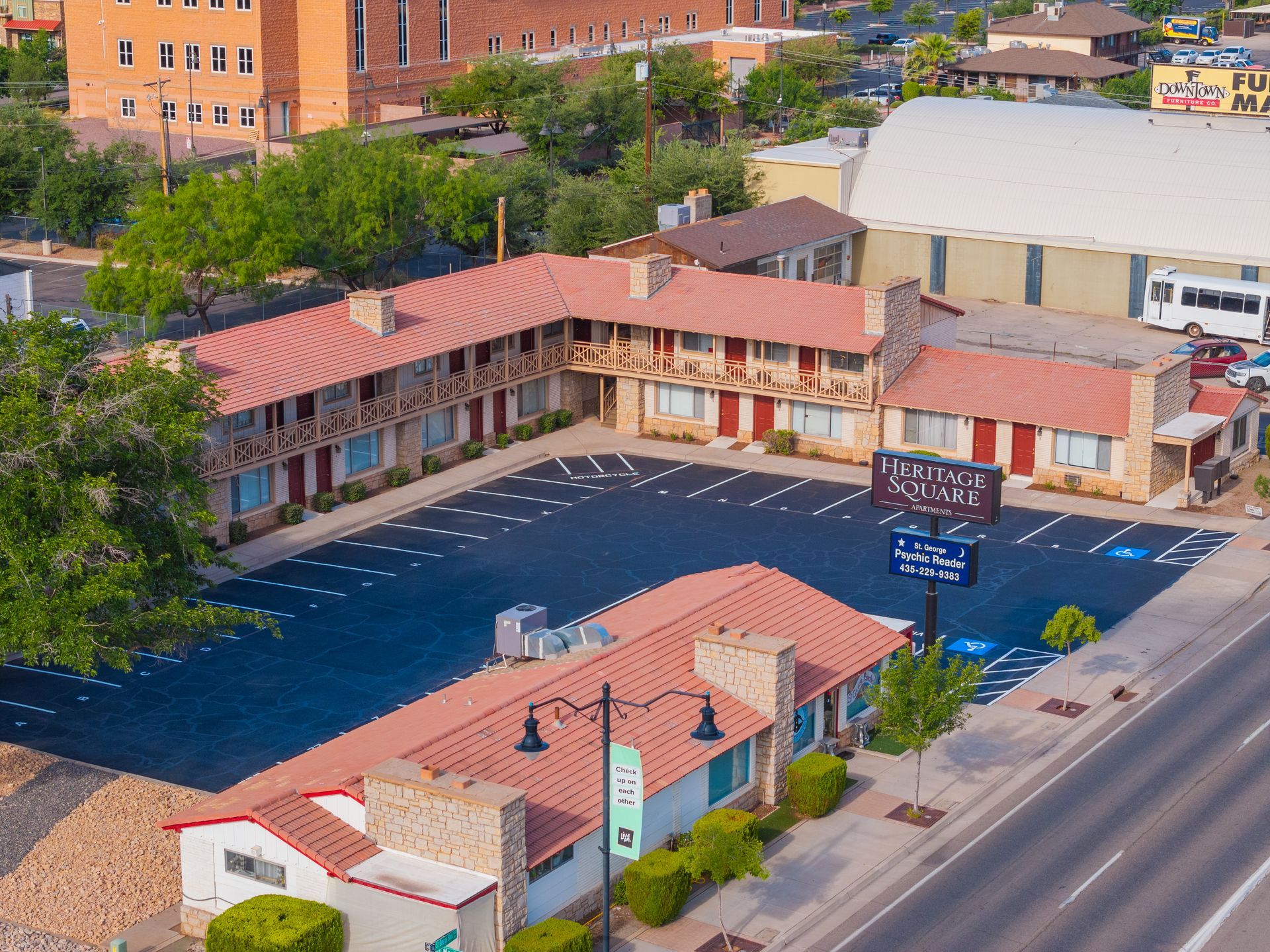 An aerial view of a motel with a large parking lot