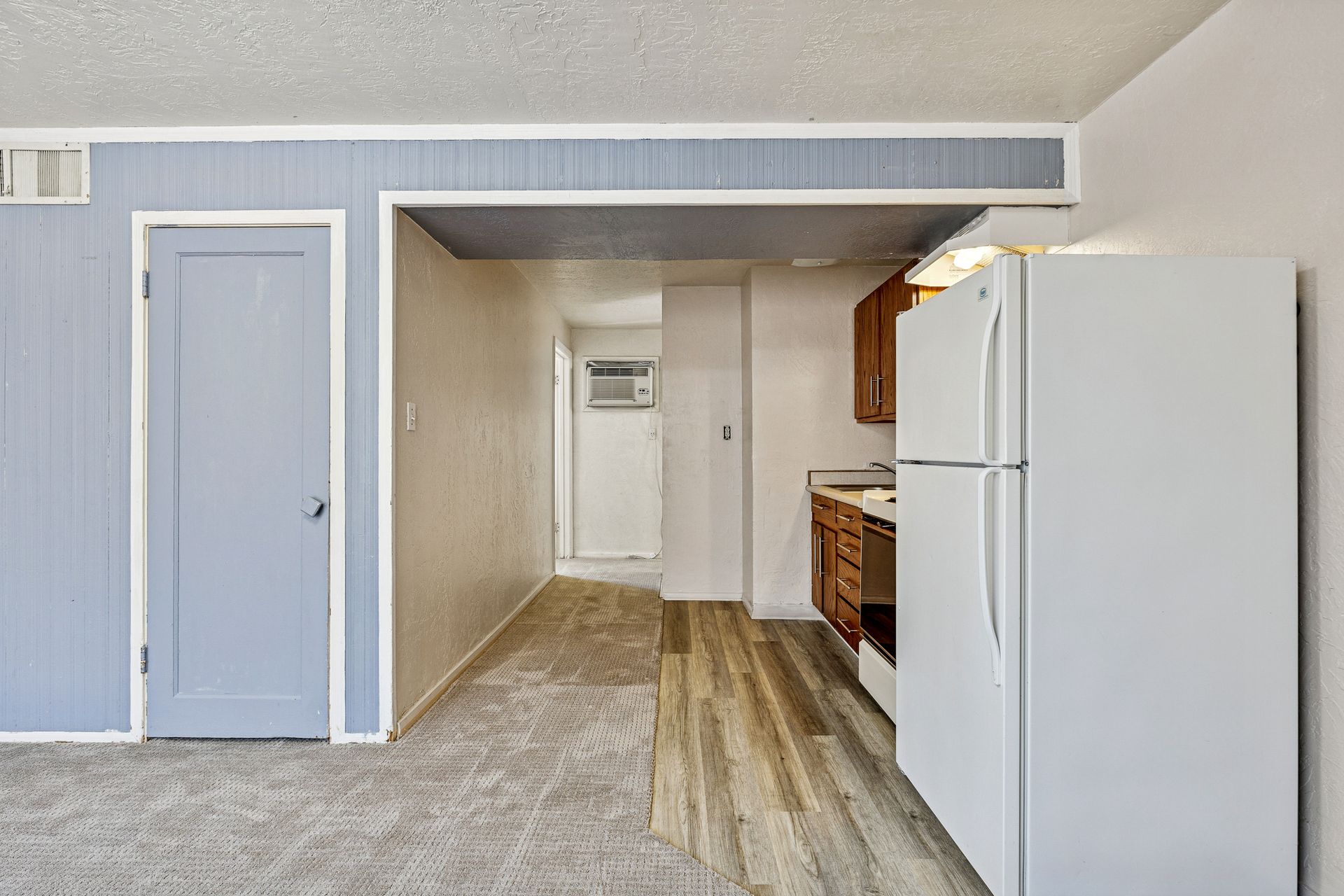 There is a refrigerator in the middle of the room.