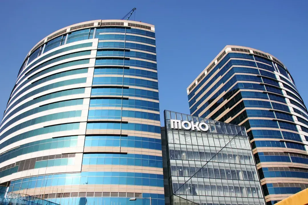 Two blue glass high-rise buildings with the