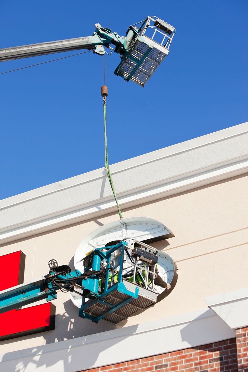 Workers Installing Commercial Building Exterior Sign — Bristol, VA — Pro Sign and Crane