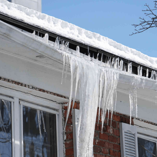 Icicles are hanging from the side of a house