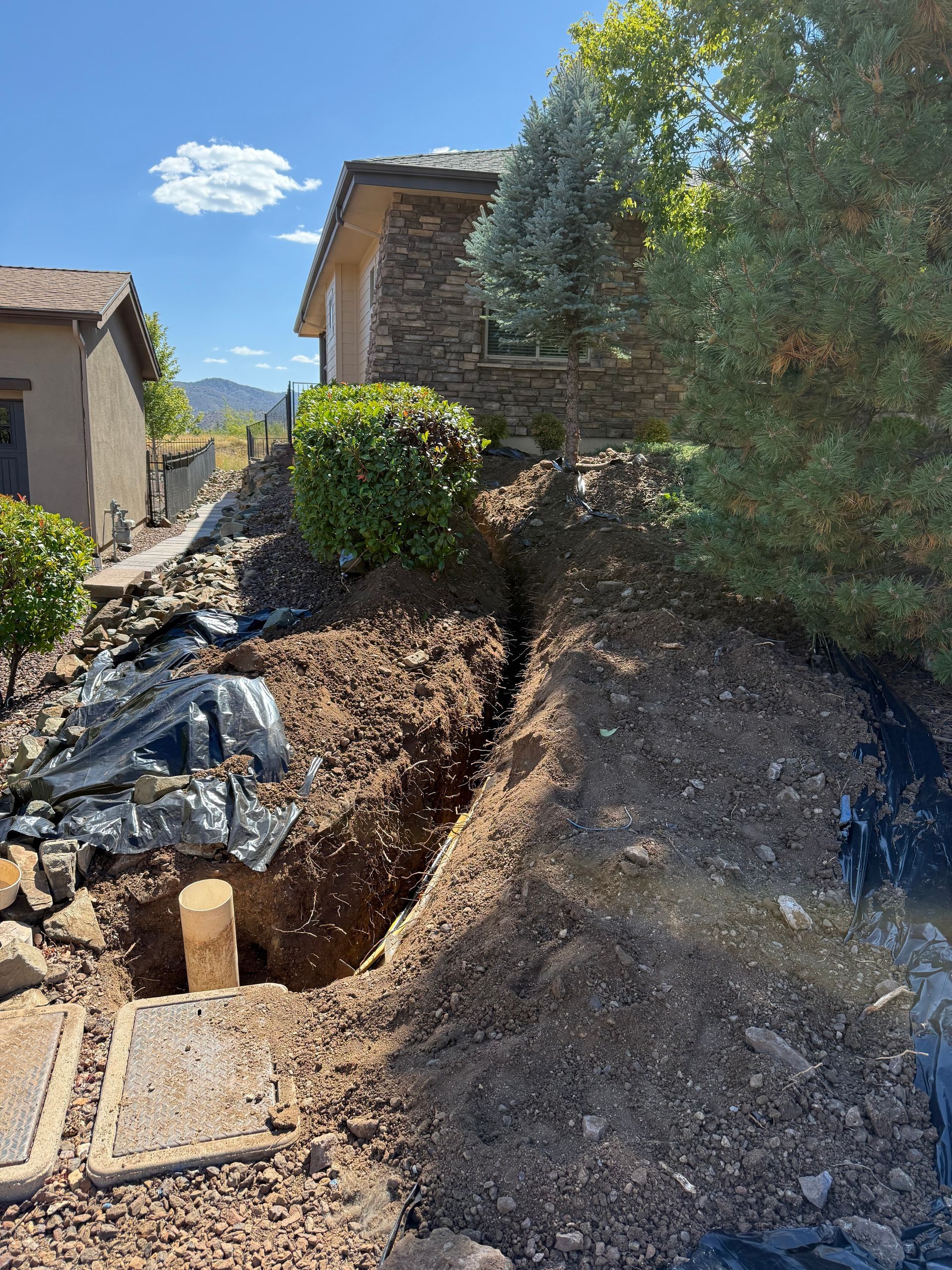 A pile of dirt is sitting in front of a house.