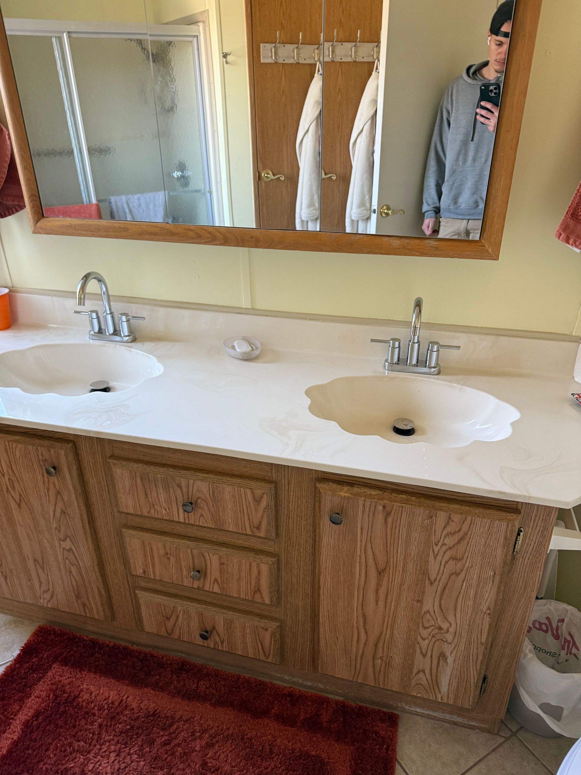 A bathroom with two sinks and a mirror.