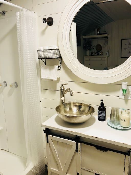 A bathroom with a sink and a large mirror