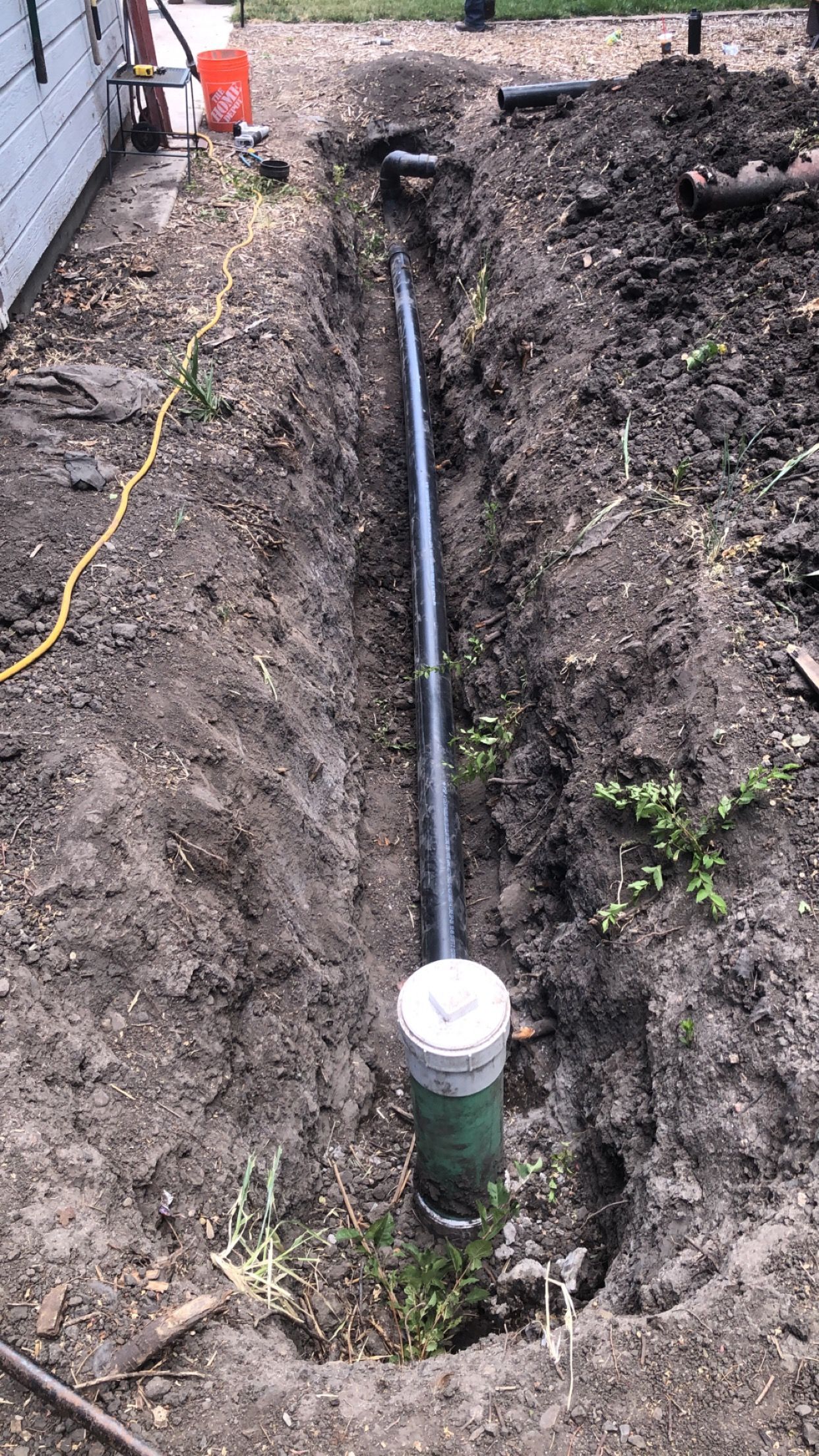 A pipe is being installed in a hole in the ground.
