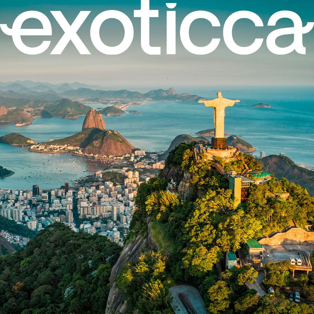 Panoramic view of Rio de Janeiro with Christ the Redeemer statue atop a mountain, and Sugarloaf Mountain in the background.